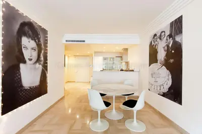 a living room with a table and chairs at GRAY 4f1 in Cannes