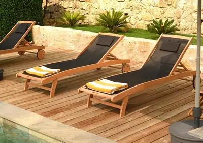 two lounge chairs on a deck next to a pool at La Villa d’Emma in Mougins