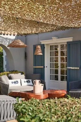 a patio with a table and chairs and a house at Cannes magnifique villa vue mer basse Californie in Cannes