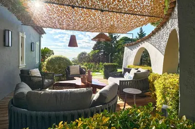 an outdoor patio with couches and tables and chairs at Cannes magnifique villa vue mer basse Californie in Cannes