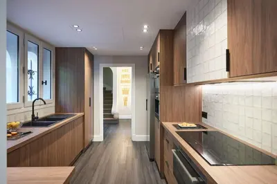 a kitchen with wooden cabinets and a sink at Cannes magnifique villa vue mer basse Californie in Cannes