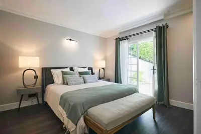 a bedroom with a large bed and a window at Cannes magnifique villa vue mer basse Californie in Cannes
