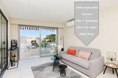 a living room with a couch and a large window at Marriott area superb 1 bedroom in Cannes