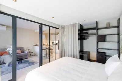 a bedroom with a bed and a living room at Marriott area superb 1 bedroom in Cannes