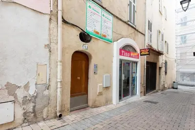 a building with a door on the side of a street at LE NID DU SUQUET une escapade idéale pour couples, près commerces, Palais et plages in Cannes