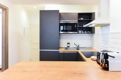 a kitchen with a counter top and a sink at LE NID DU SUQUET une escapade idéale pour couples, près commerces, Palais et plages in Cannes