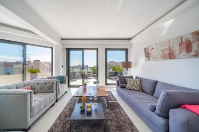 a living room with couches and a table at Cannes centre dernier étage in Cannes