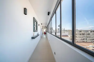 an empty corridor in a building with windows at Cannes centre dernier étage in Cannes