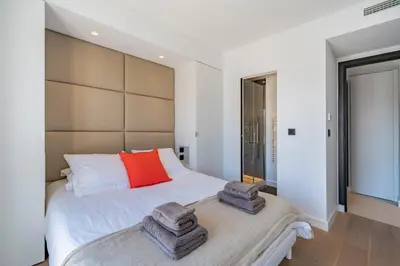 a bedroom with a bed with two towels on it at Cannes centre dernier étage in Cannes
