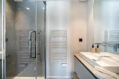 a bathroom with a glass shower and a sink at Cannes centre dernier étage in Cannes