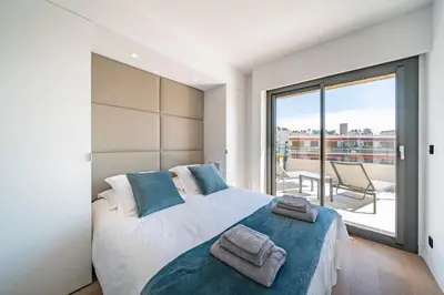 a bedroom with a large bed with towels on it at Cannes centre dernier étage in Cannes