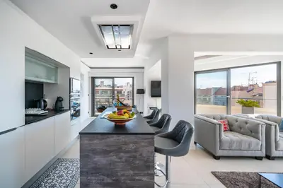a kitchen and living room with a table and chairs at Cannes centre dernier étage in Cannes