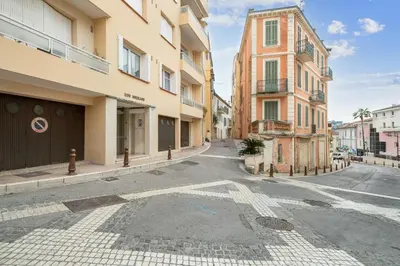 an empty street in a city with buildings at Appartement Sauvalie - Welkeys in Le Cannet