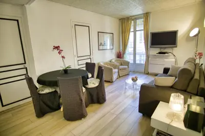 a living room with a couch and a table at Ref JOFFRE - Palmes d'Or Properties in Cannes