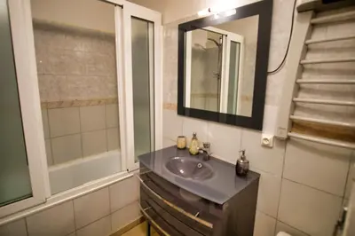 a bathroom with a sink and a mirror at Ref JOFFRE - Palmes d'Or Properties in Cannes