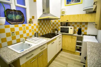 a small kitchen with a sink and a microwave at Ref JOFFRE - Palmes d'Or Properties in Cannes