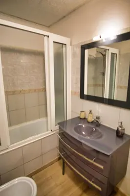 a bathroom with a sink and a mirror at Ref JOFFRE - Palmes d'Or Properties in Cannes