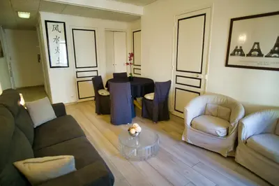 a living room with a couch and chairs and a table at Ref JOFFRE - Palmes d'Or Properties in Cannes
