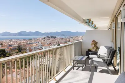 a balcony with a view of a city at Cannes Panorama - Piscine, vue mer, parking, clim in Cannes