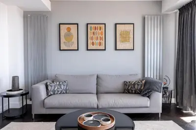 a living room with a couch and a table at Cannes Panorama - Piscine, vue mer, parking, clim in Cannes
