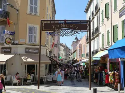 a street sign in a city with people walking down a street at Cannes Studio situé dans la résidence Gallia Historique in Cannes