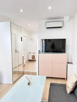 a living room with a glass table and a tv at 1 Bedroom flat with Balcony Cannes Center Croisette 6ppl in Cannes