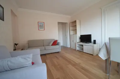 a living room with a couch and a television at Charming Stanislas Studio with Wi-Fi and Air Conditioning in Cannes