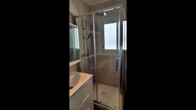 a bathroom with a shower and a sink and a window at Charming Stanislas Studio with Wi-Fi and Air Conditioning in Cannes