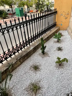 a black fence with some plants in front of it at Maisonnette Studio bas Suquet, proche plage et palais in Cannes