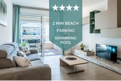 a living room with a couch and a tv at 1-Br apartment in Palm Beach swimming pool in Cannes
