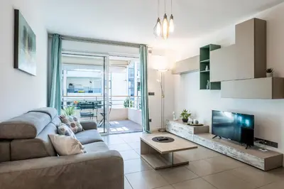 a living room with a couch and a flat screen tv at 1-Br apartment in Palm Beach swimming pool in Cannes