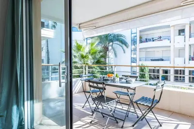 a balcony with a table and chairs at 1-Br apartment in Palm Beach swimming pool in Cannes