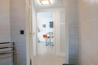 a bathroom with a walk in shower next to a table at 1-Br apartment in Palm Beach swimming pool in Cannes