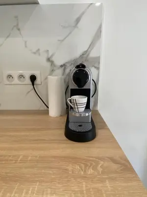 a black blender sitting on a wooden table at Studio centre ville cannes in Cannes