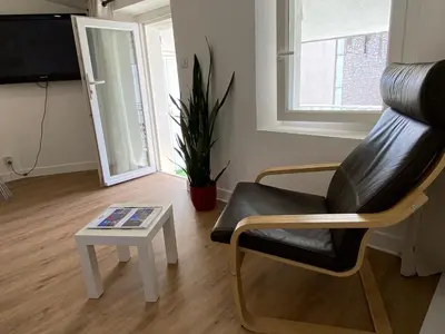 a living room with a chair and a table at Studio centre ville cannes in Cannes