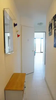a kitchen with a white refrigerator and a hallway at Appartement 753, 4 personnes, vue mer By Palmazur in Cannes