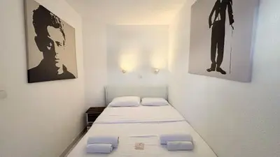 a small room with a bed and two pictures on the wall at Appartement 753, 4 personnes, vue mer By Palmazur in Cannes