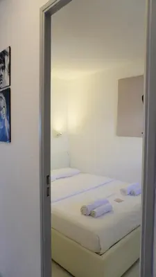 a bedroom with two beds with white sheets at Appartement 753, 4 personnes, vue mer By Palmazur in Cannes