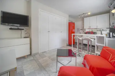 a kitchen with a white table and white cabinets at FRGK FR - Surcouf 'PALM BEACH ' in Cannes