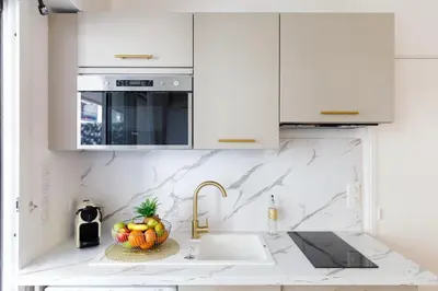 a kitchen with a sink and a bowl of fruit at Perle Dorée YourHostHelper in Cannes