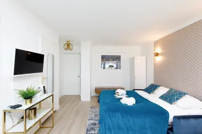 a hotel room with a bed and a tv at Perle Dorée YourHostHelper in Cannes