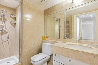a bathroom with a toilet and a sink and a mirror at croisette3bedroomterrasse in Cannes
