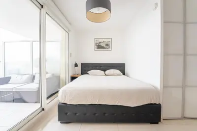 a bedroom with a large bed and a mirror at Joli studio centre Cannes in Cannes