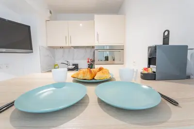 two blue plates on a wooden table in a kitchen at Joli studio centre Cannes in Cannes