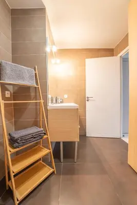 a bathroom with a sink and a white door at Joli studio centre Cannes in Cannes