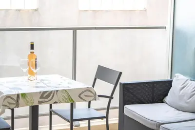 a table with a bottle of wine and two chairs at Joli studio centre Cannes in Cannes