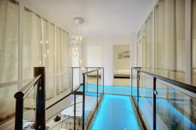 a swimming pool on a glass walkway in a building at Duplex 5 chambres PATIO, Clémenceau-CENTRE CANNES A5B003 in Cannes