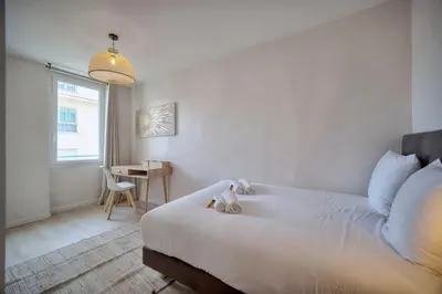 a bedroom with a bed with a teddy bear on it at Duplex 5 chambres PATIO, Clémenceau-CENTRE CANNES A5B003 in Cannes