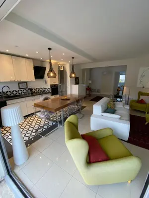 a living room with a couch and a table at Grand appartement de style avec parking - Cannes in Cannes