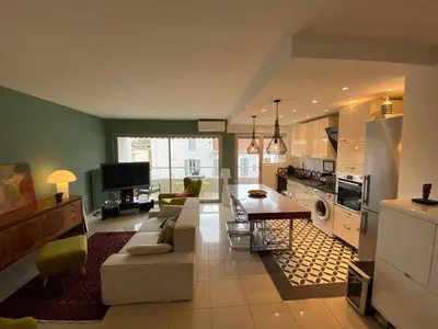 a kitchen and living room with a couch and a table at Grand appartement de style avec parking - Cannes in Cannes